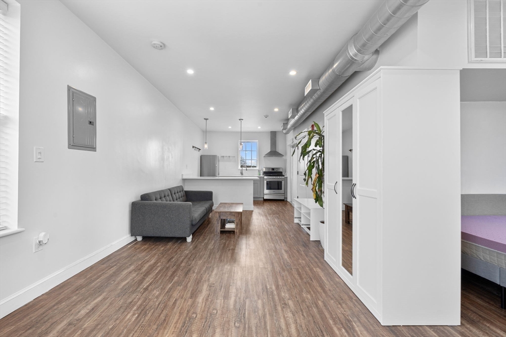 105 Broadway, Unit 2 Chelsea, MA 02150 - Photo 3 of 9 a living room with furniture and a wooden floor