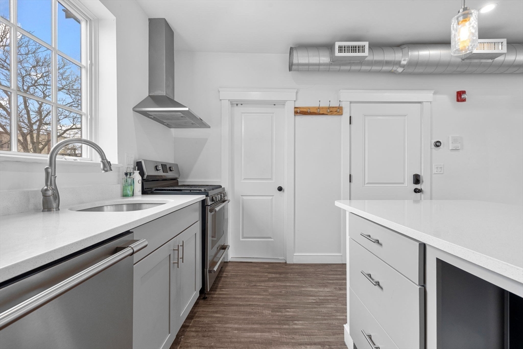 105 Broadway, Unit 2 Chelsea, MA 02150 - Photo 6 of 9 a kitchen with stainless steel appliances a sink and cabinets