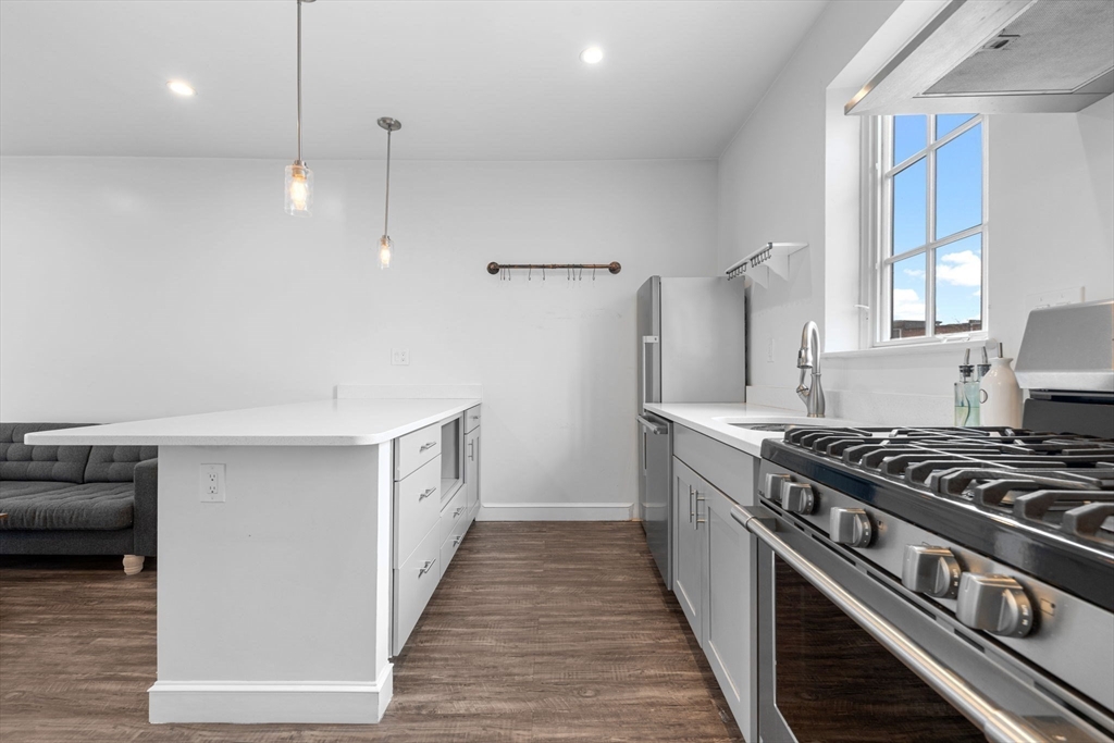 105 Broadway, Unit 2 Chelsea, MA 02150 - Photo 8 of 9 a kitchen with stove and cabinets