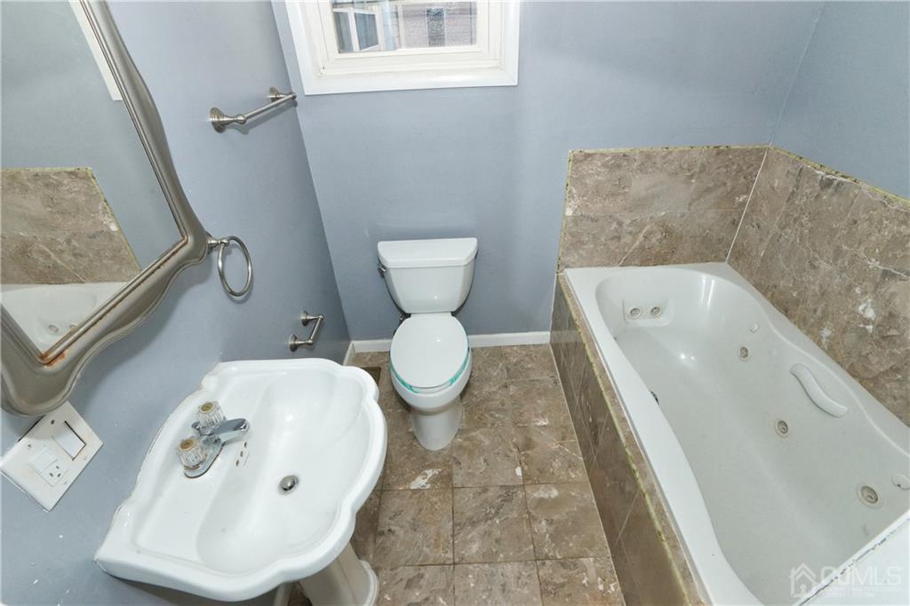 59 Willow Road Metuchen, NJ 08840 - Photo 12 of 23 a bathroom with a toilet sink and mirror