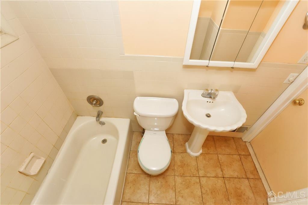 59 Willow Road Metuchen, NJ 08840 - Photo 18 of 23 a bathroom with a sink and mirror