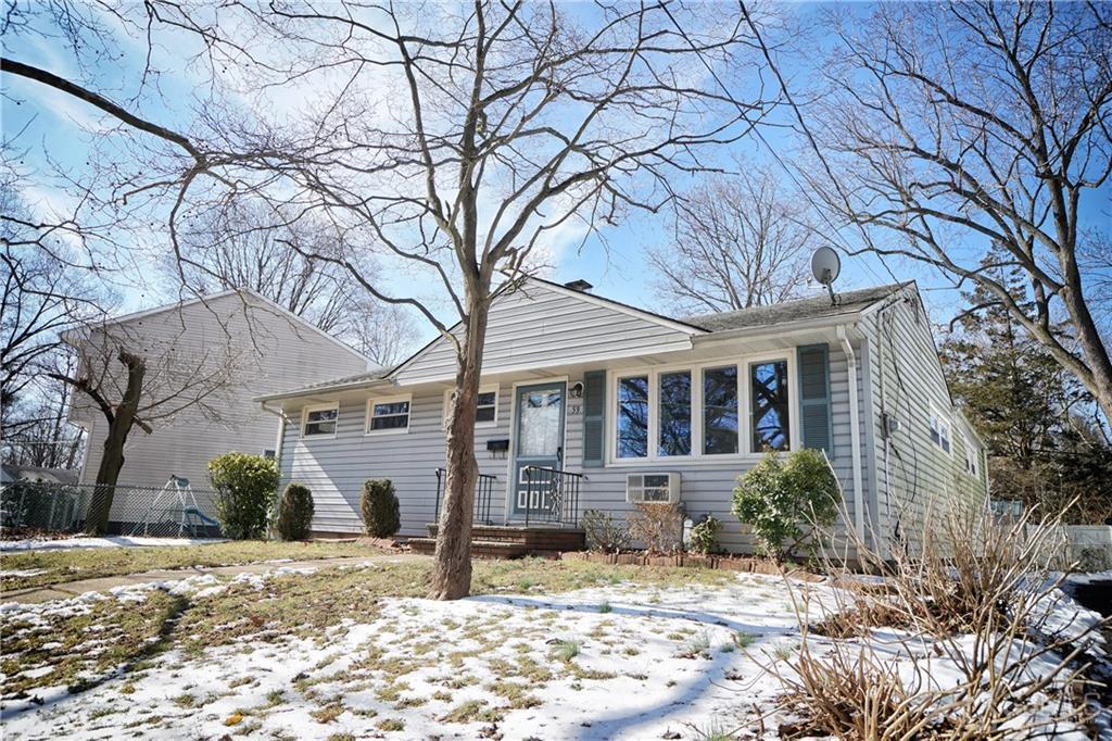 59 Willow Road Metuchen, NJ 08840 - Photo 2 of 23 a front view of a house with a yard and potted plants