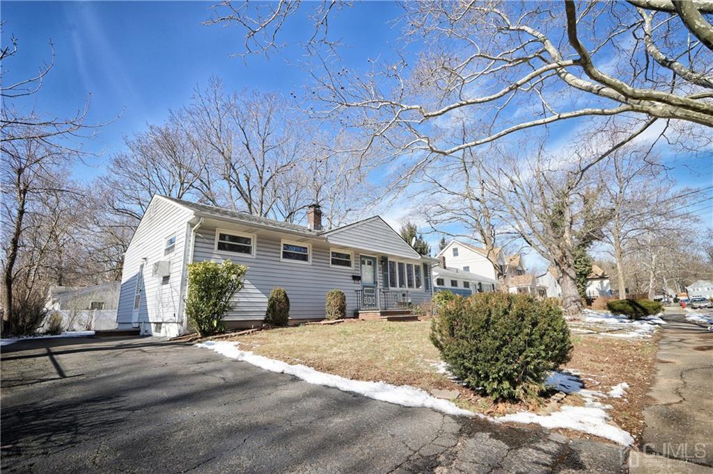 59 Willow Road Metuchen, NJ 08840 - Photo 3 of 23 a front view of a house with a yard and garage
