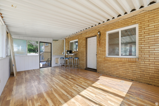 1486 3rd Street Ogden, UT 84404 - Photo 21 of 26 Enclosed porch with wood-finish flooring, white paneled walls, and a corrugated ceiling