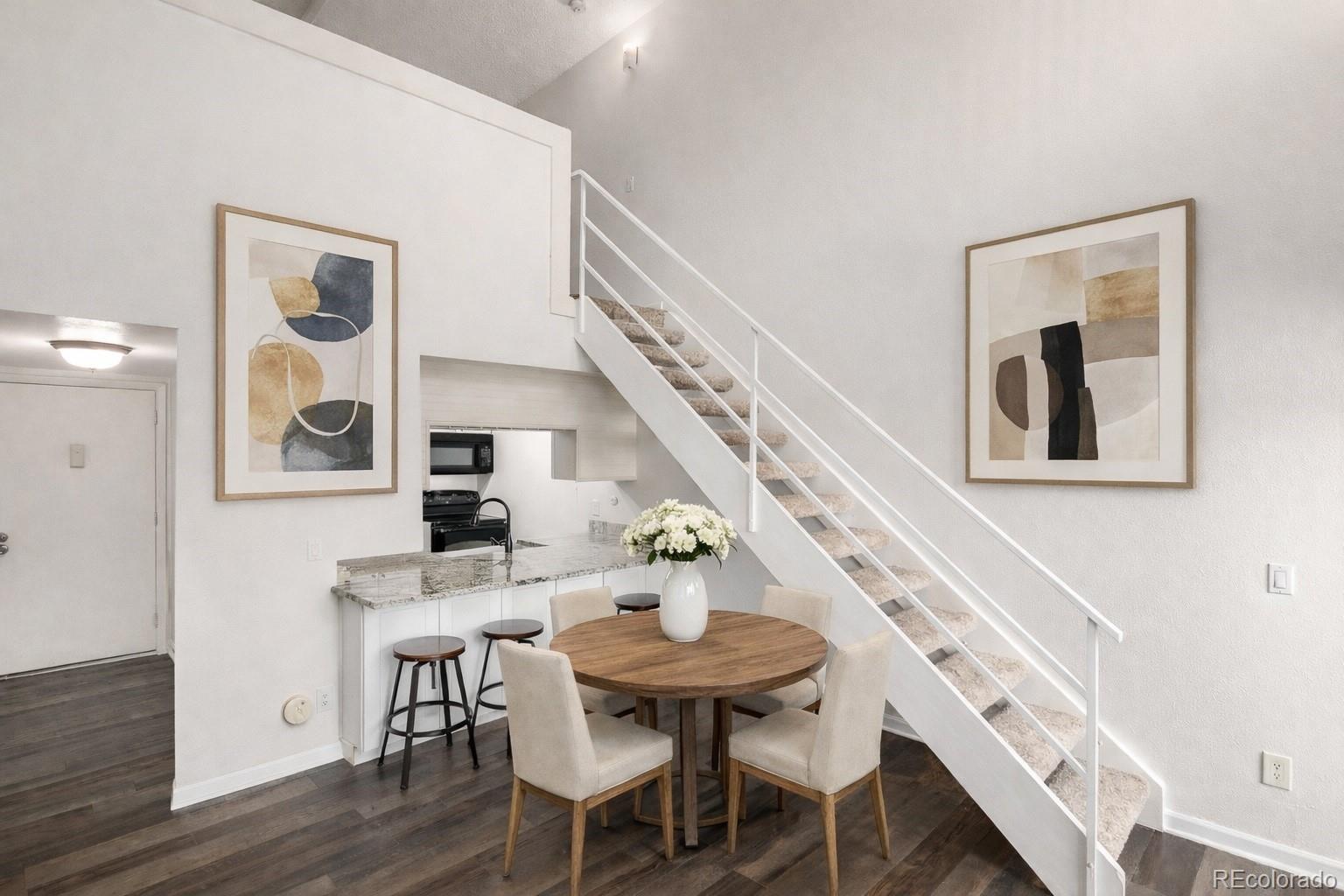 4896 South Dudley Street, Unit 910 Littleton, CO 80123 - Photo 2 of 30 a view of a dining room with furniture and wooden floor