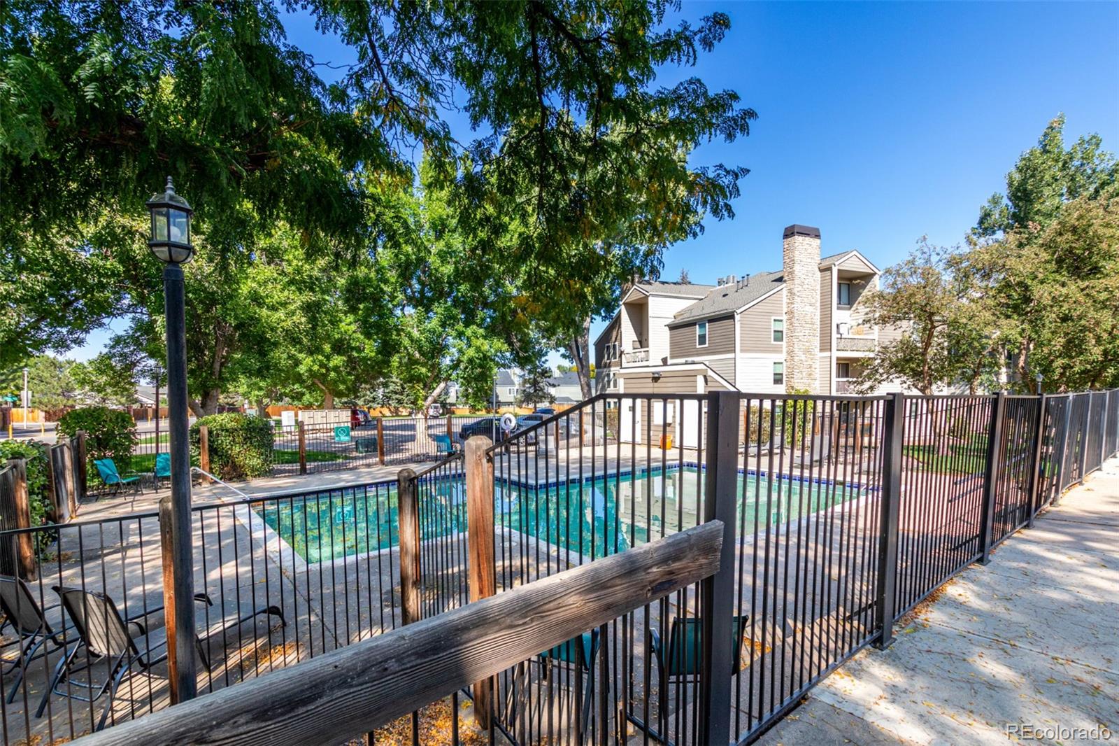 4896 South Dudley Street, Unit 910 Littleton, CO 80123 - Photo 25 of 30 a view of a houses with a trees from a balcony