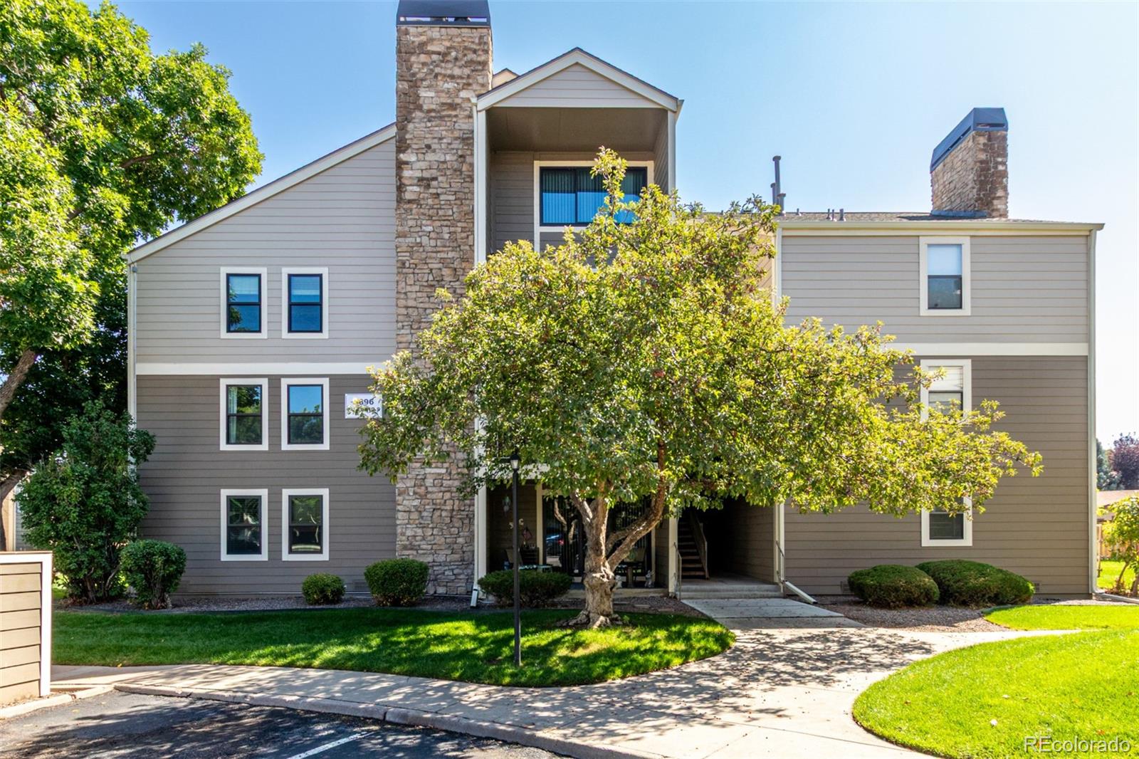4896 South Dudley Street, Unit 910 Littleton, CO 80123 - Photo 26 of 30 a front view of a house with garden