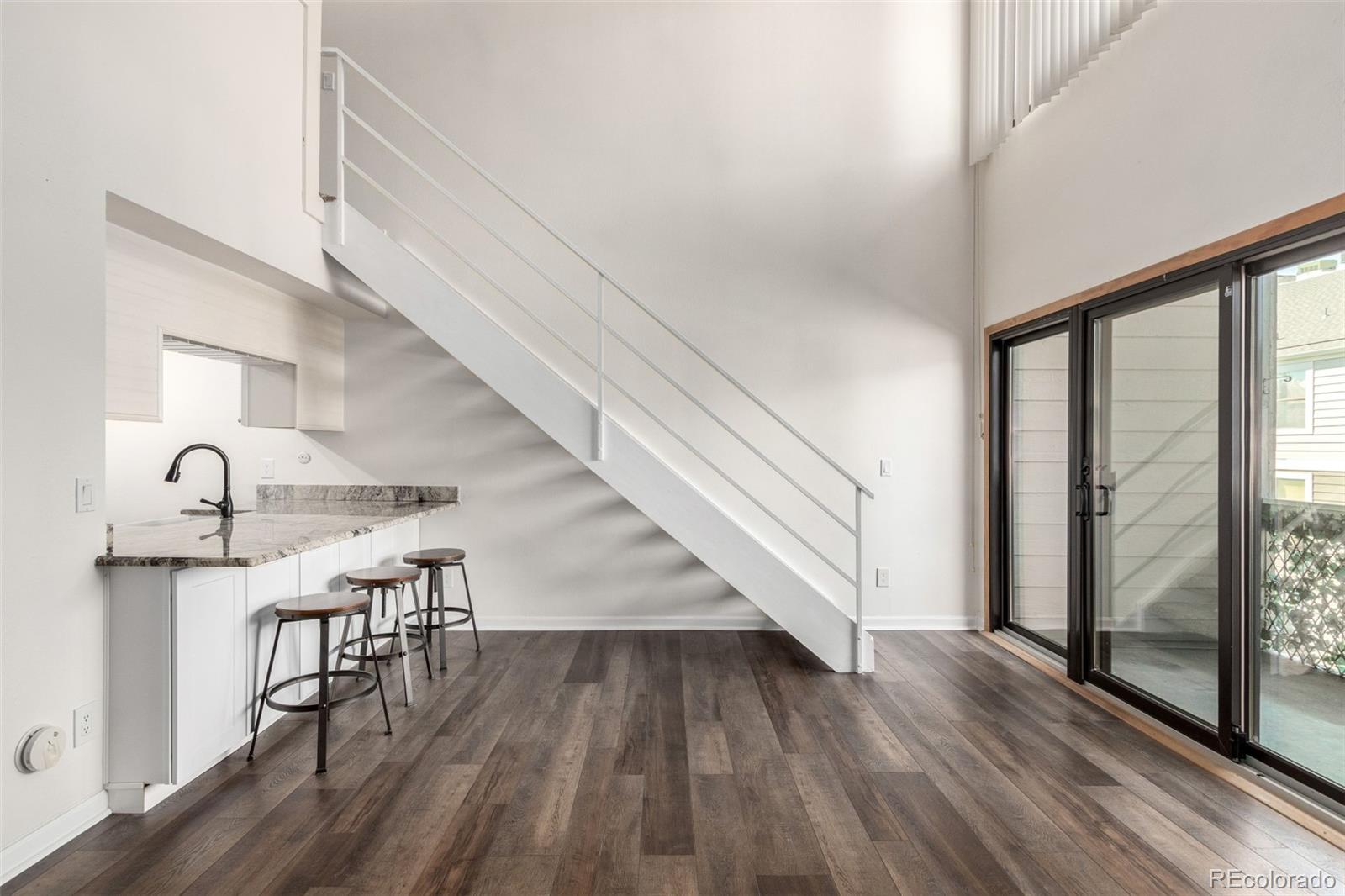 4896 South Dudley Street, Unit 910 Littleton, CO 80123 - Photo 3 of 30 a view of entryway and hall with wooden floor
