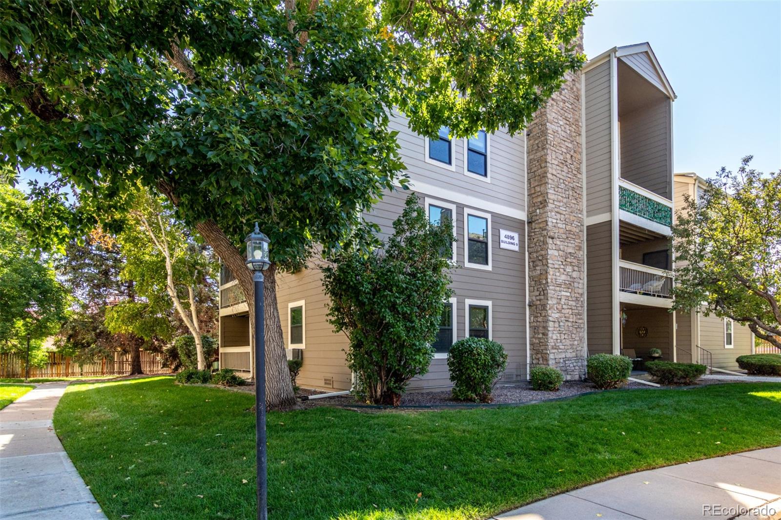 4896 South Dudley Street, Unit 910 Littleton, CO 80123 - Photo 6 of 30 a front view of a house with a yard