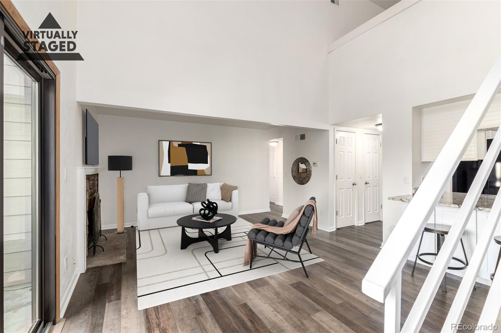 4896 South Dudley Street, Unit 910 Littleton, CO 80123 - Photo 7 of 30 a living room with furniture and a wooden floor