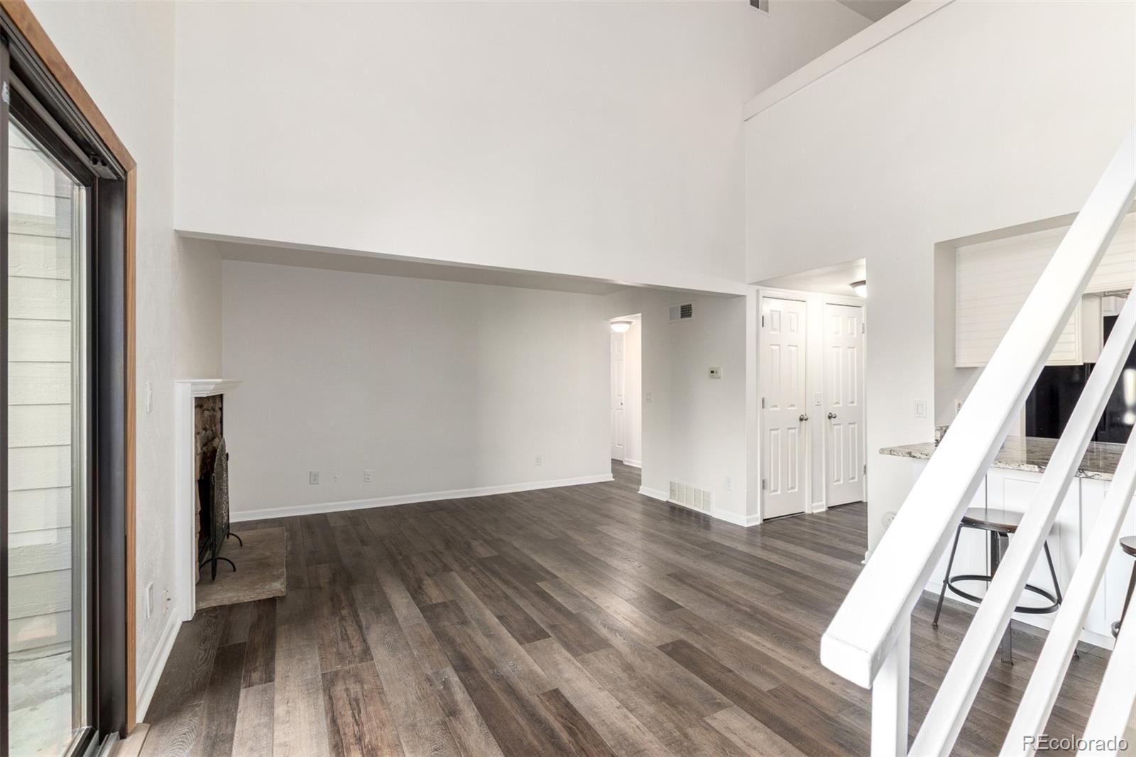 4896 South Dudley Street, Unit 910 Littleton, CO 80123 - Photo 8 of 30 a view of an empty room with wooden floor and a window