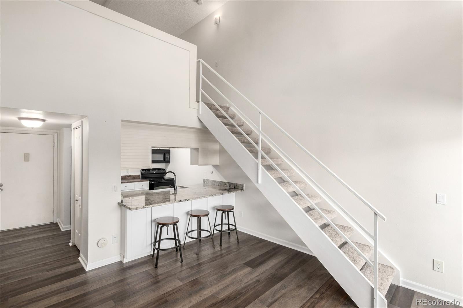 4896 South Dudley Street, Unit 910 Littleton, CO 80123 - Photo 10 of 30 a view of entryway and hall with wooden floor