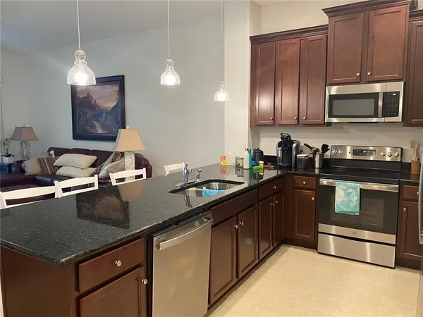 a kitchen with a sink stove and microwave