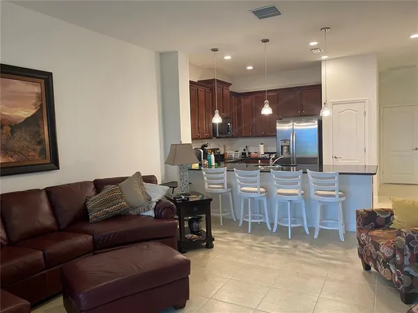 a living room with furniture a kitchen view and kitchen view