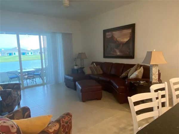 a living room with furniture and a floor to ceiling window