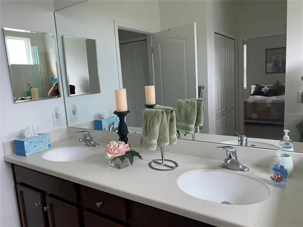 a bathroom with double vanity sinks and a mirror