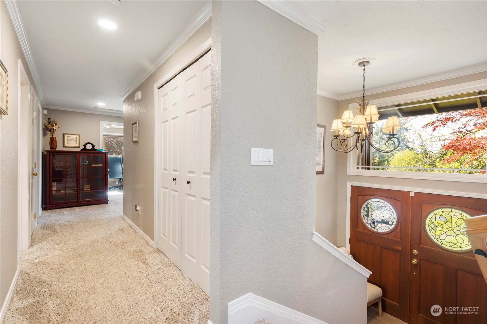 120 221st Street Southwest Bothell, WA 98021 - Photo 16 of 40 a view of a hallway with wooden floor and a chandelier