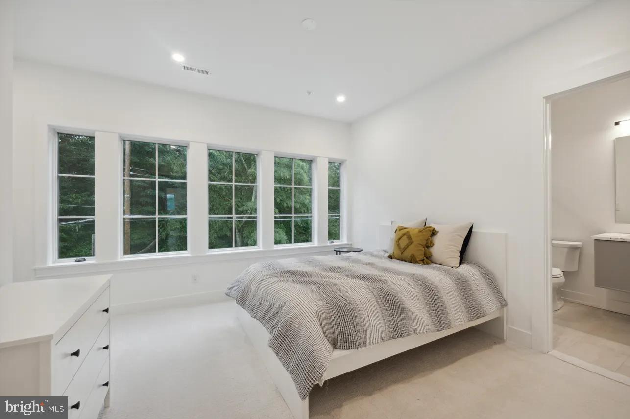 8201 Shawnee Street Philadelphia, PA 19118 - Photo 13 of 22 a bedroom with a bed and a large window