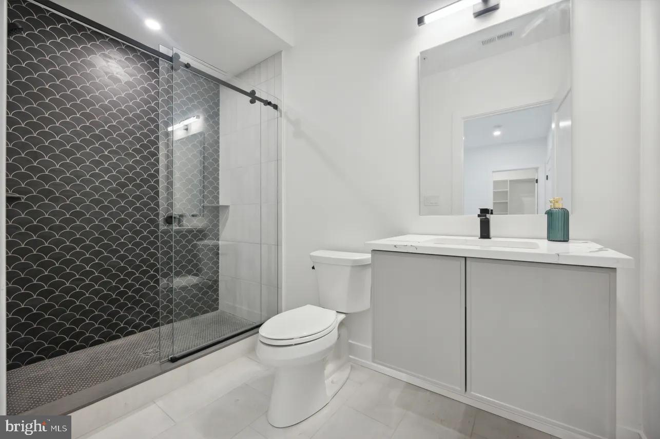 8201 Shawnee Street Philadelphia, PA 19118 - Photo 14 of 22 a bathroom with a sink a toilet and shower