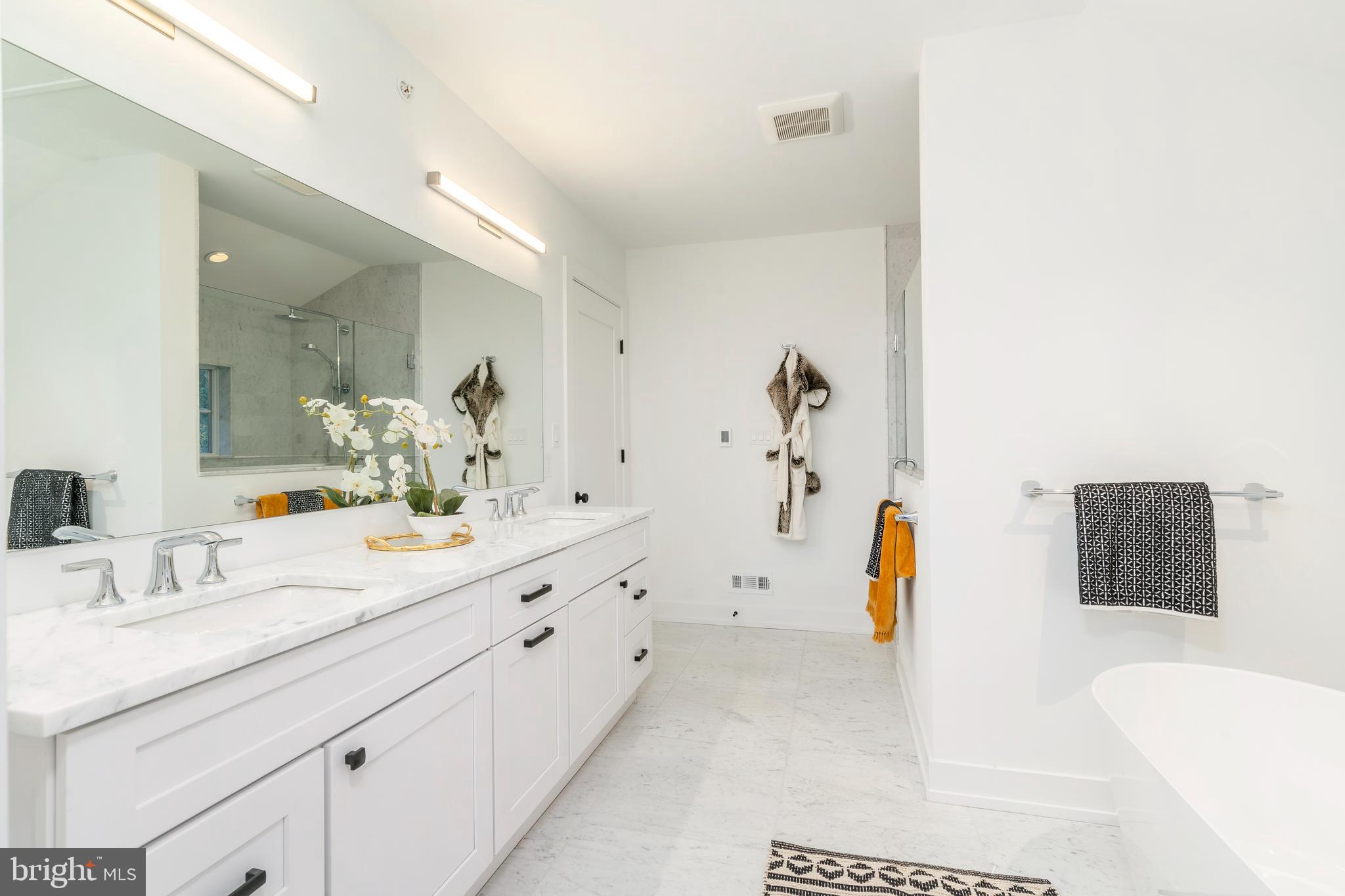 8201 Shawnee Street Philadelphia, PA 19118 - Photo 10 of 22 a spacious bathroom with a tub sink and mirror