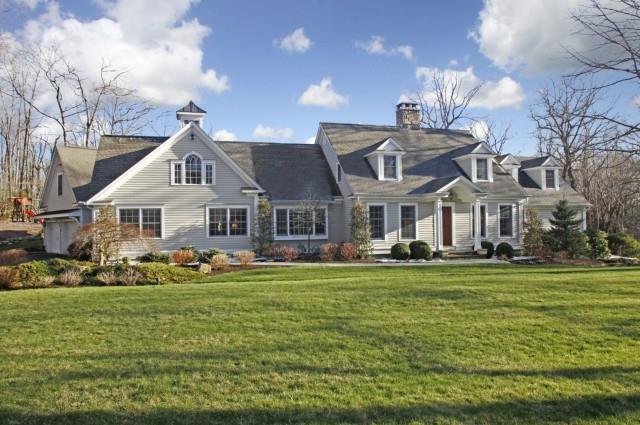 22 Comstock Court Ridgefield, CT 06877 - Photo 1 of 1 a front view of a house with swimming pool and green space