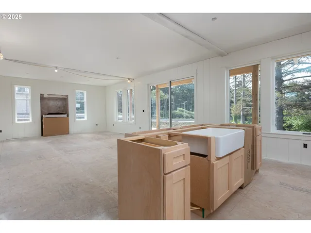 a view of a kitchen with kitchen island a sink and a stove