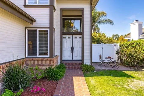 a front view of a house with garden