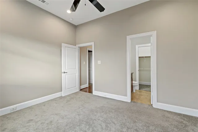 an empty room with windows and closet