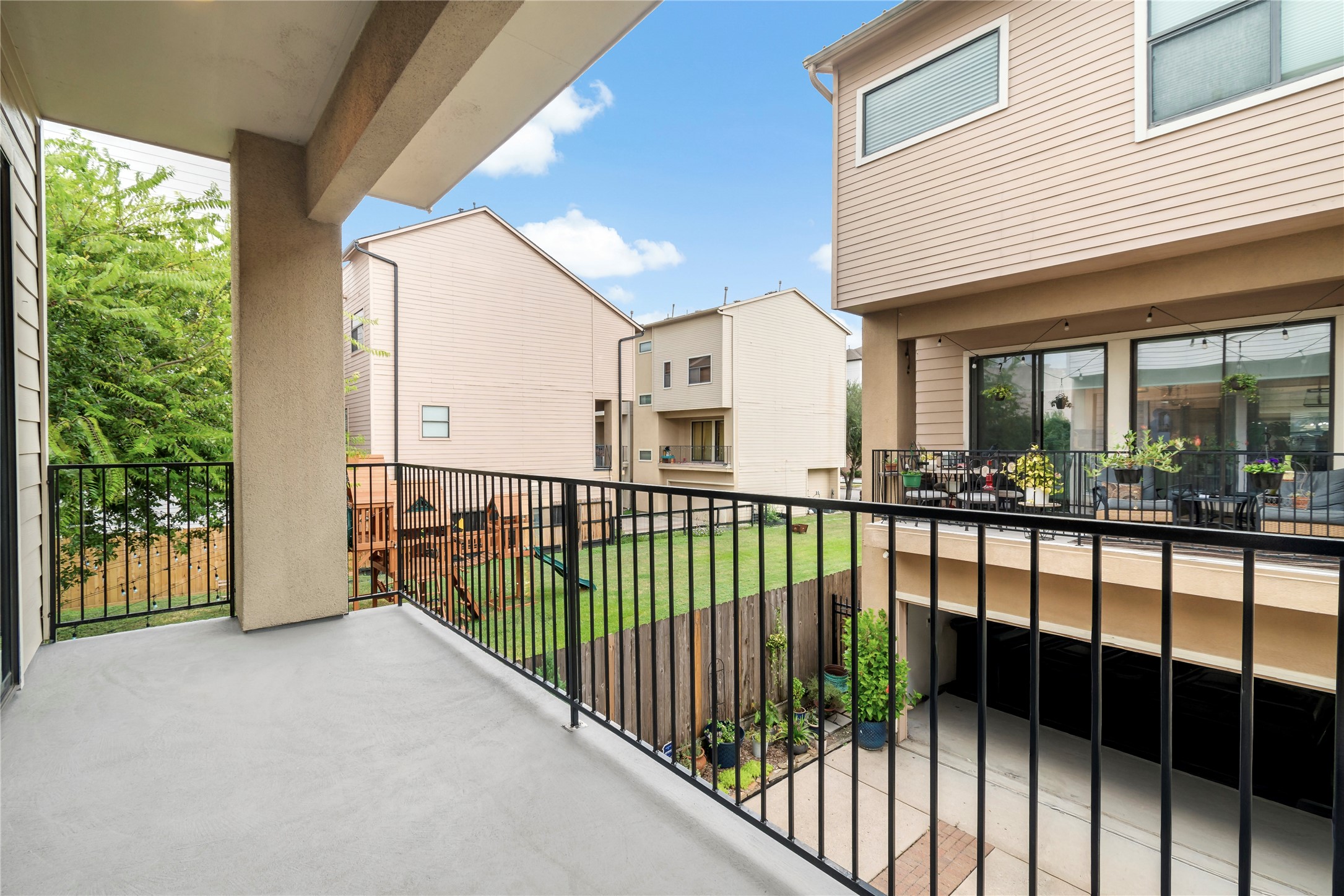 808 Paige Street Houston, TX 77003 - Photo 8 of 23 Step onto the inviting balcony off the main living area and enjoy a cozy, sunset-lit retreat with city views, perfect for relaxing or entertaining.