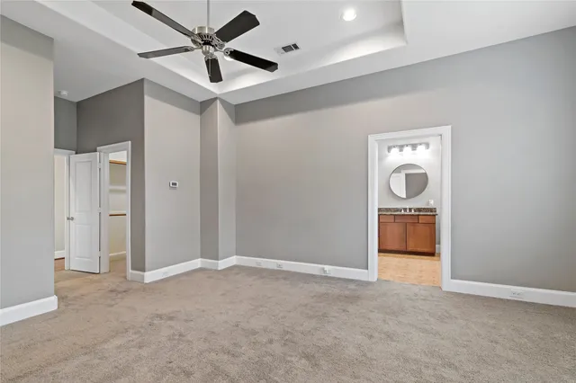 a view of a livingroom with a chandelier fan and a kitchen