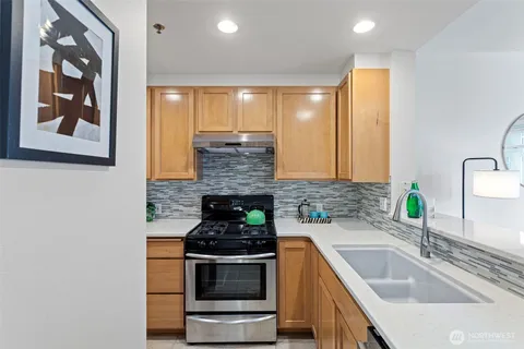 a bathroom with a toilet and a wooden floor