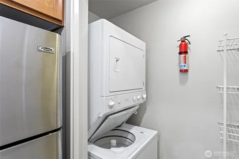a bedroom with a bed a couch and a potted plant on the dresser