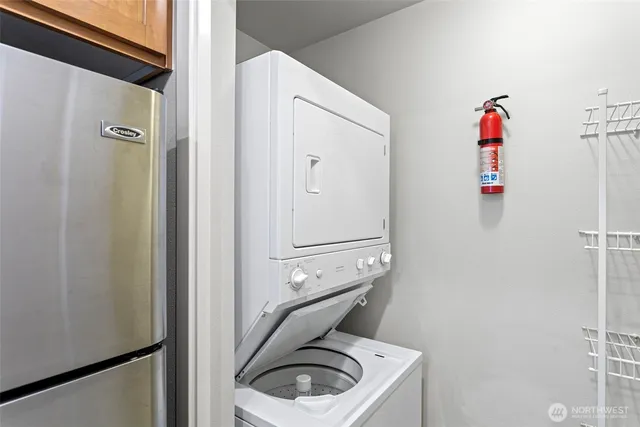 a bedroom with a bed a couch and a potted plant on the dresser