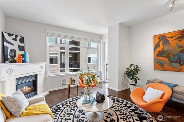 a view of a balcony with chairs and a potted plant