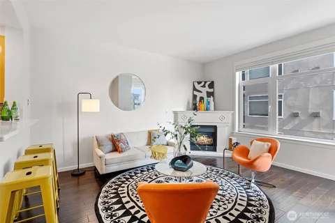 a living room with furniture a flat screen tv and a table