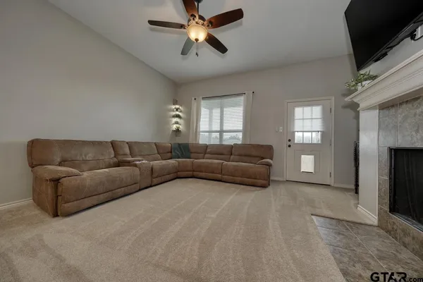 a living room with furniture and a fireplace
