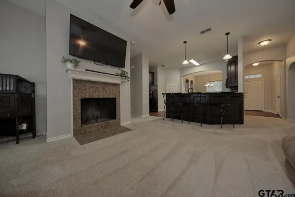 a living room with furniture a flat screen tv and a fireplace