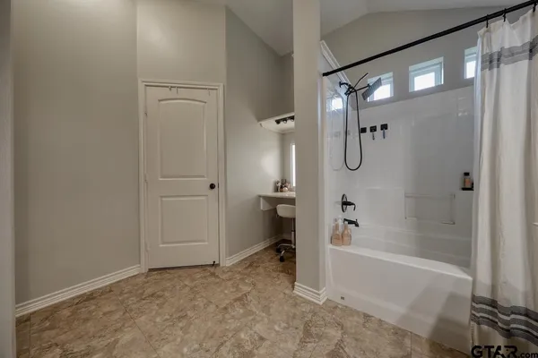 a bathroom with a bathtub and a shower