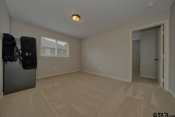 an empty room with windows and closet