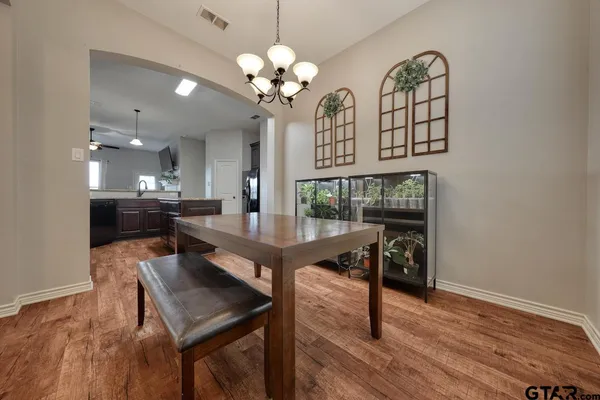 a view of a dining room with furniture and wooden floor