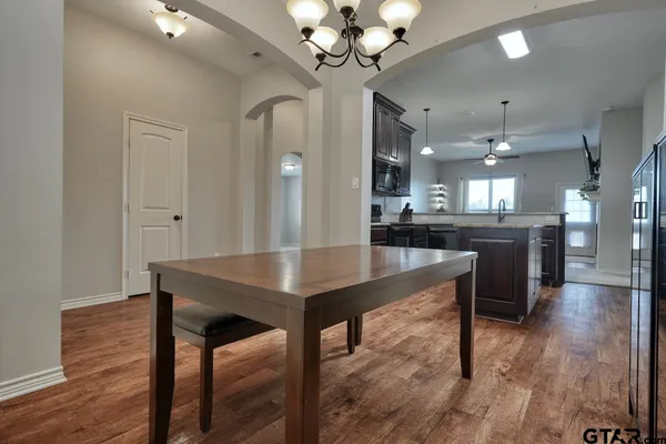 a view of a dining room with furniture and wooden floor