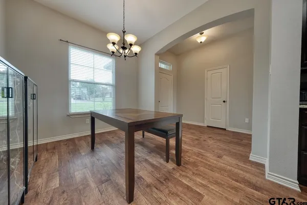 a view of a livingroom with furniture window wooden floor and a chandelier