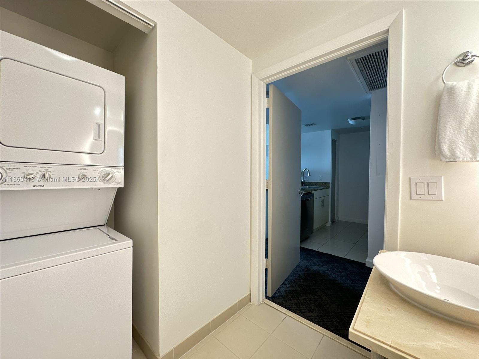 2889 McFarlane Road, Unit 1814 Miami, FL 33133 - Photo 11 of 12 a bathroom with a sink and a toilet