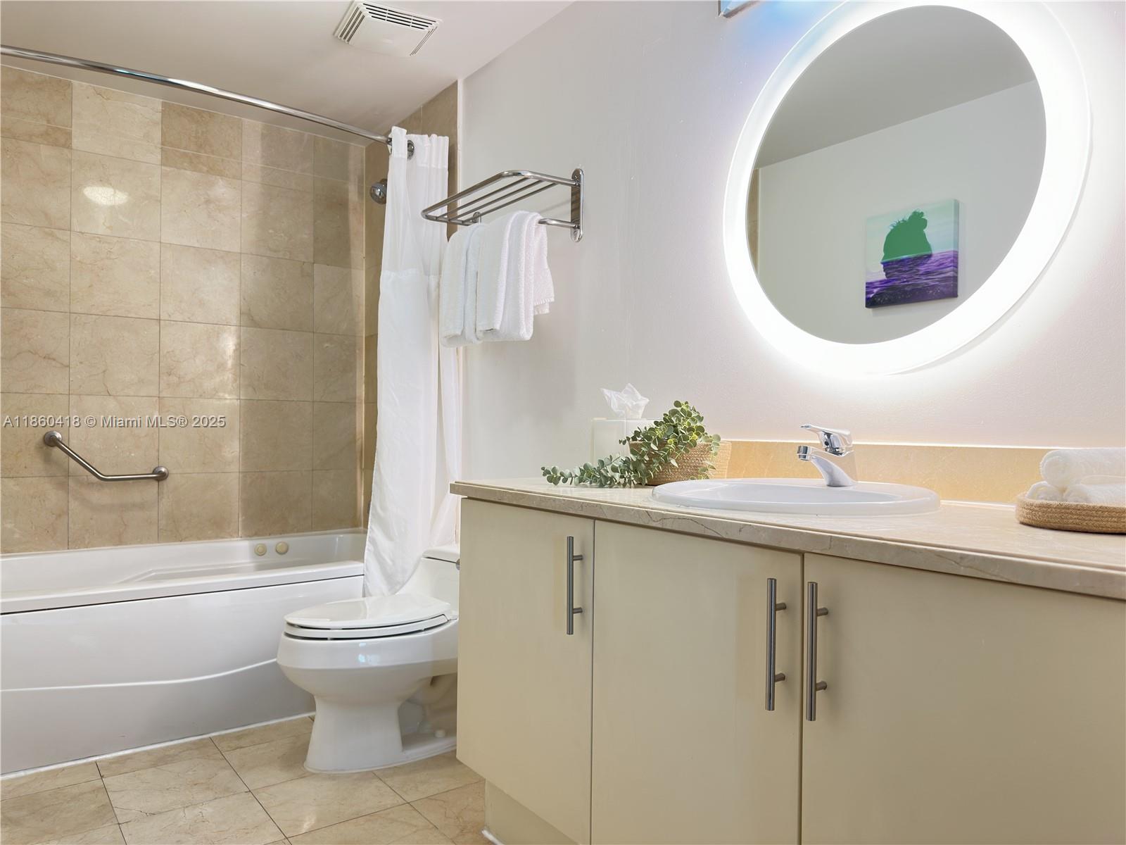 2889 McFarlane Road, Unit 1814 Miami, FL 33133 - Photo 12 of 12 a bathroom with a sink toilet and shower