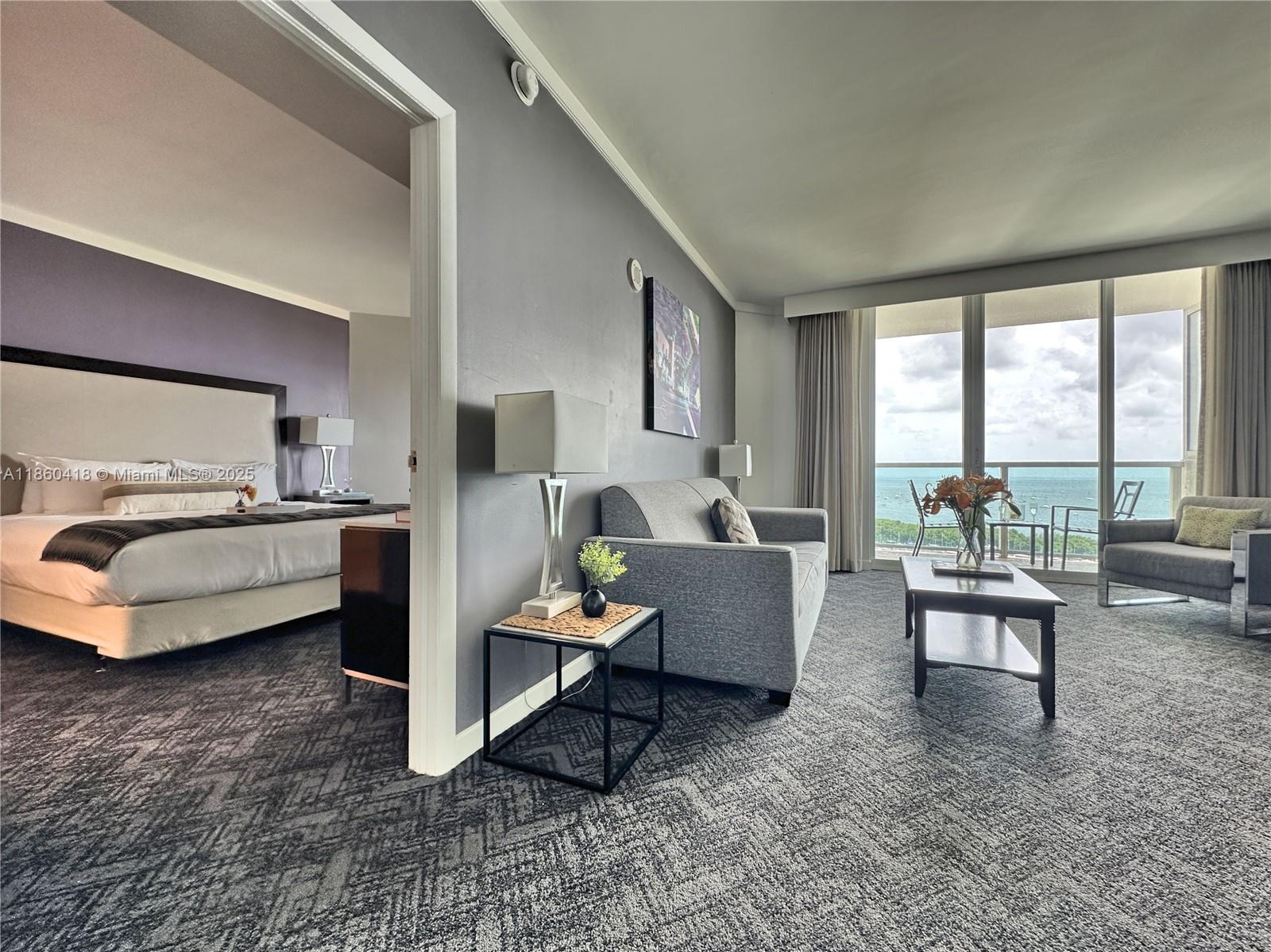 2889 McFarlane Road, Unit 1814 Miami, FL 33133 - Photo 2 of 12 a living room with furniture and a large window