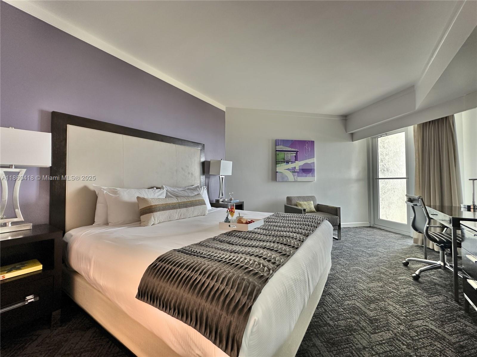 2889 McFarlane Road, Unit 1814 Miami, FL 33133 - Photo 3 of 12 a bedroom with a bed and large windows