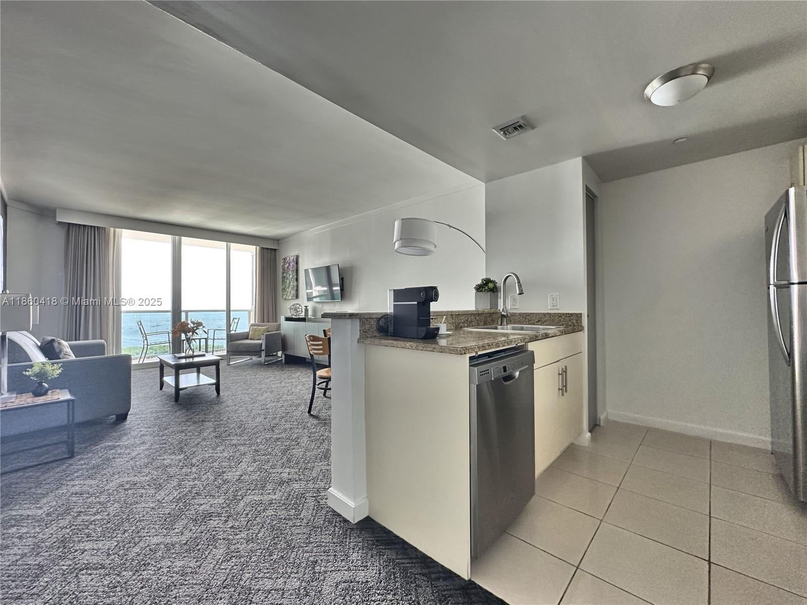 2889 McFarlane Road, Unit 1814 Miami, FL 33133 - Photo 4 of 12 a kitchen with a sink and counter top space