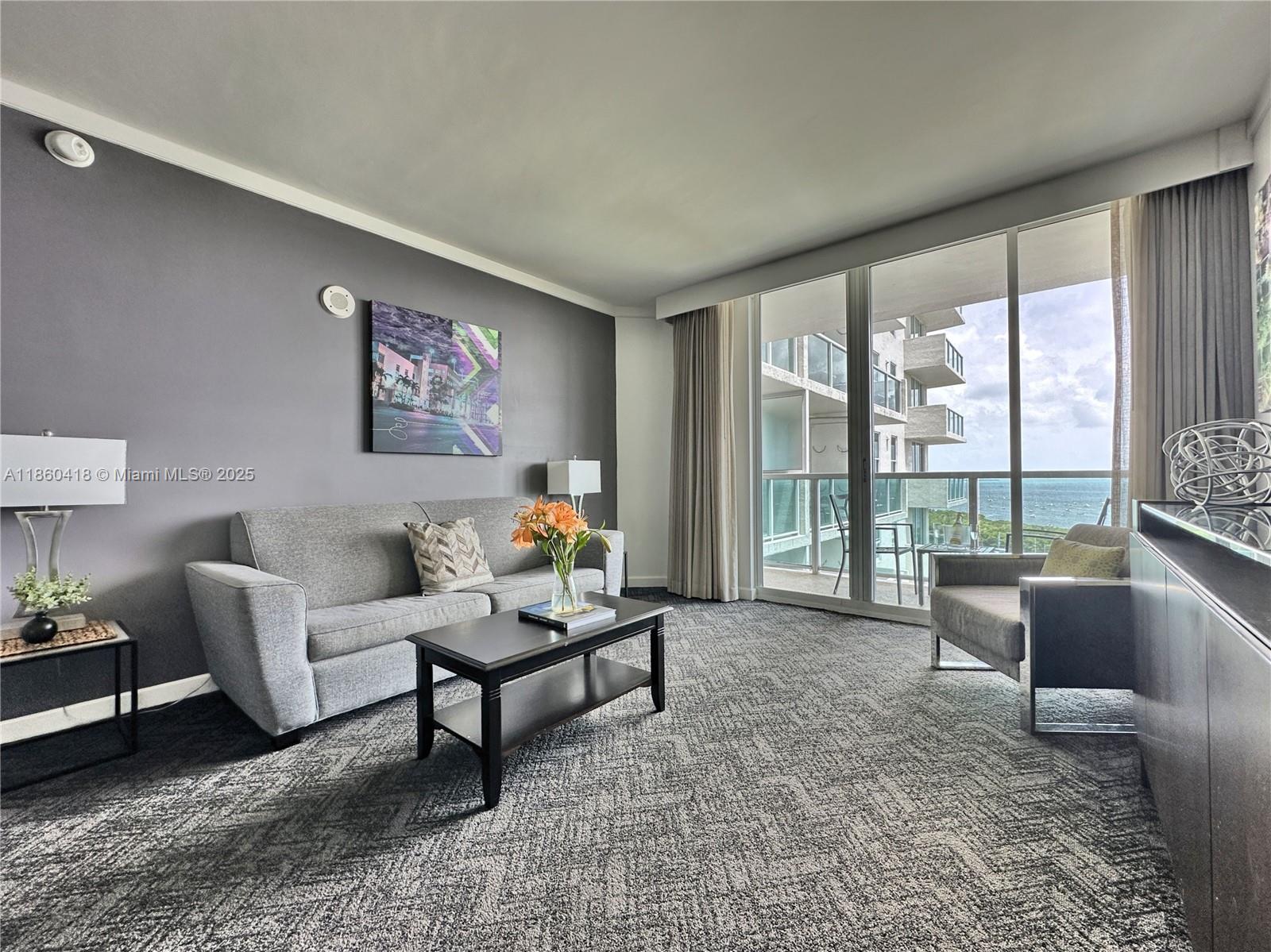 2889 McFarlane Road, Unit 1814 Miami, FL 33133 - Photo 7 of 12 a living room with furniture and a large window
