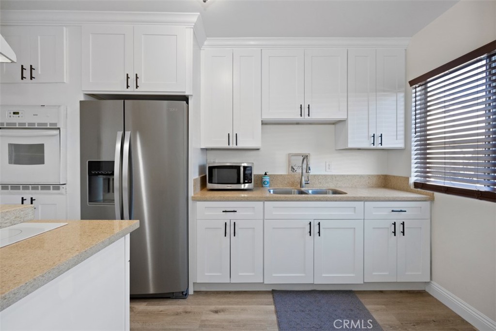 14609 Christine Drive, Unit 9 Whittier, CA 90605 - Photo 18 of 44 New self-closing kitchen cabinets/drawers, new countertops and new laminate flooring.