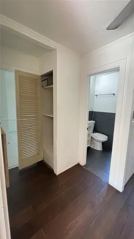 a view of a room with wooden floor and white walls